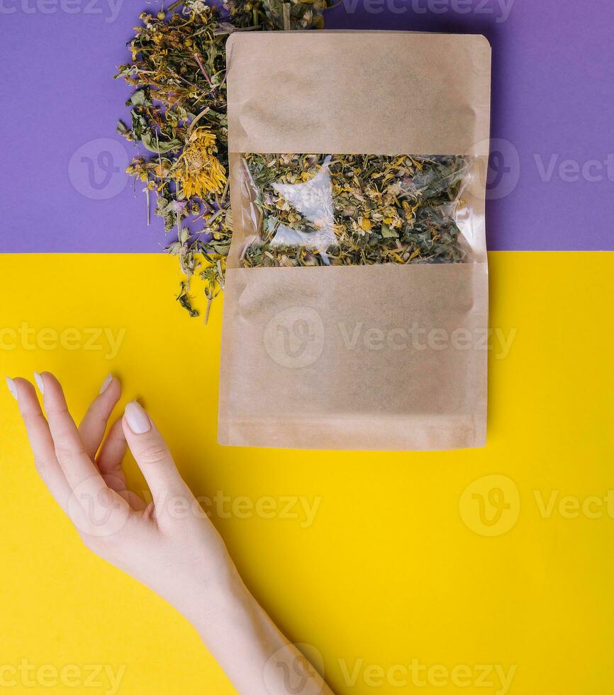 Paper bag with dry loose leaf tea photo