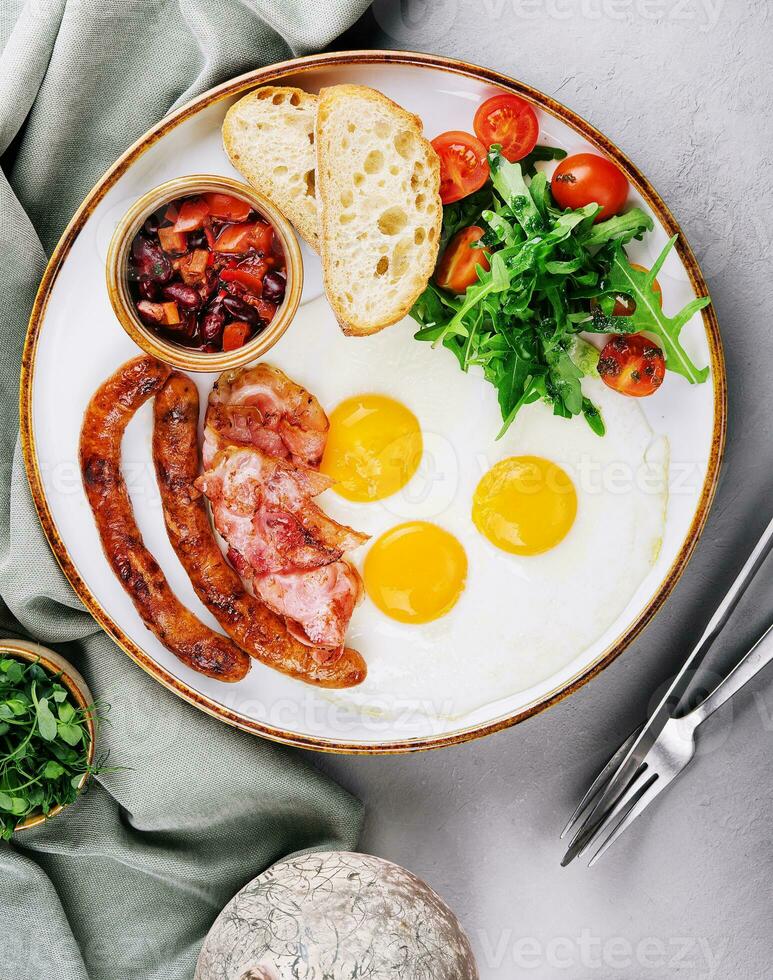 Fried eggs and bacon for breakfast on a plate photo