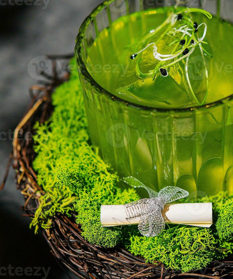 A green alcoholic drink in a clear glass photo