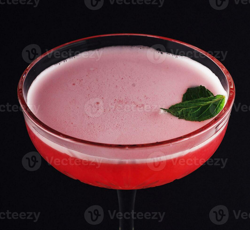 Red, sweet berry cocktail with froth photo