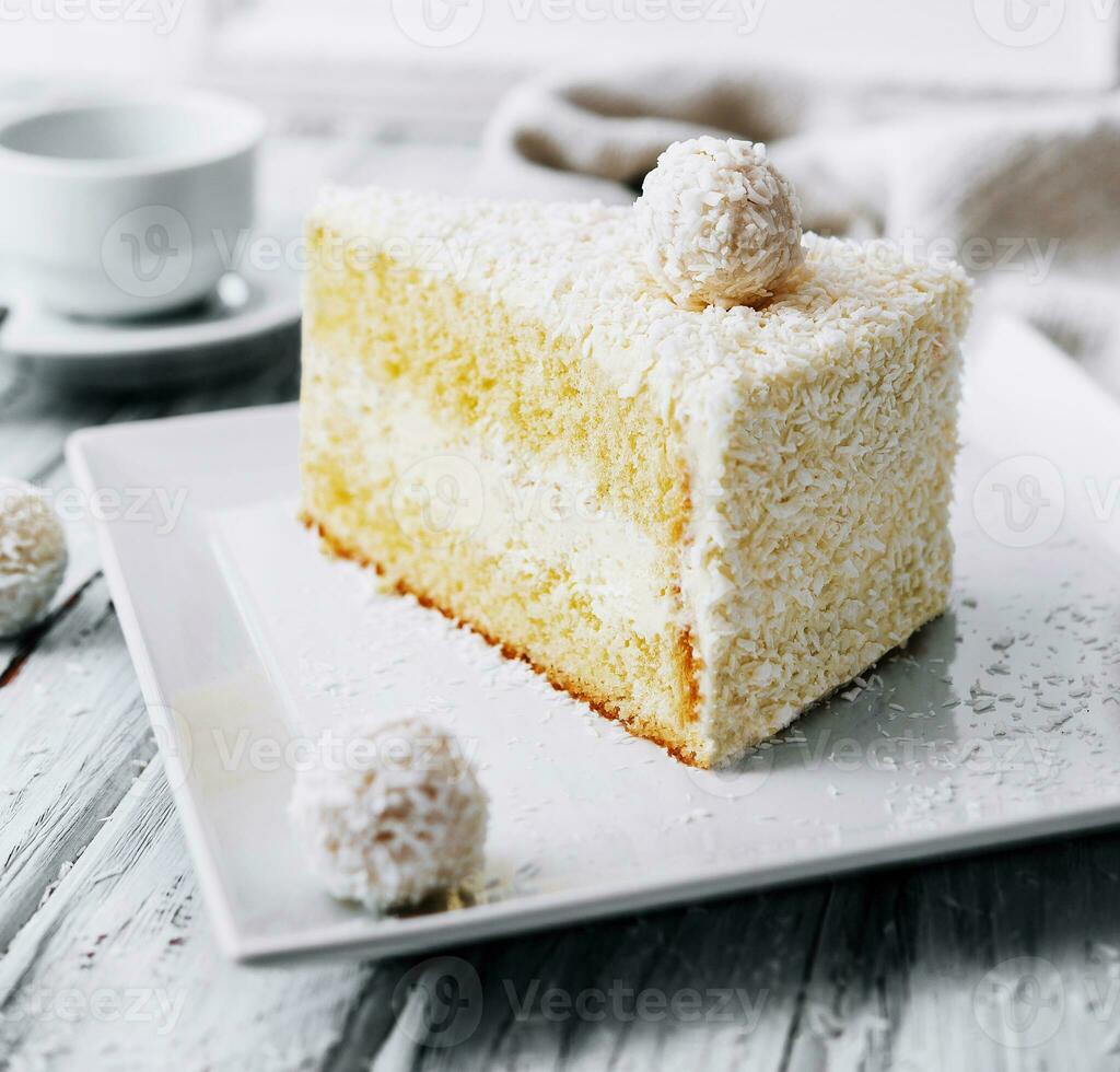 Coconut layered, raffaello cake on white plate photo