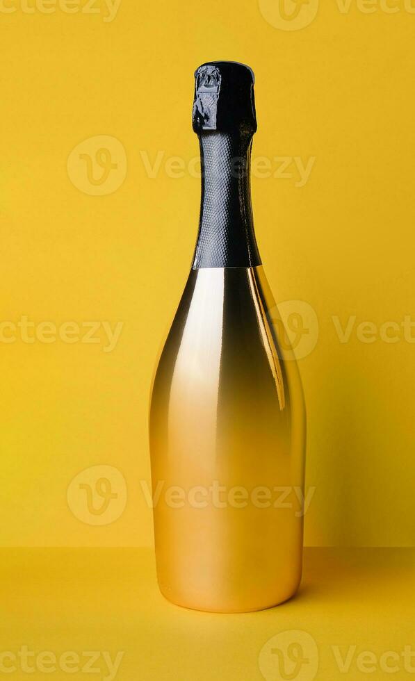 golden elegant bottle of champagne on a yellow background photo