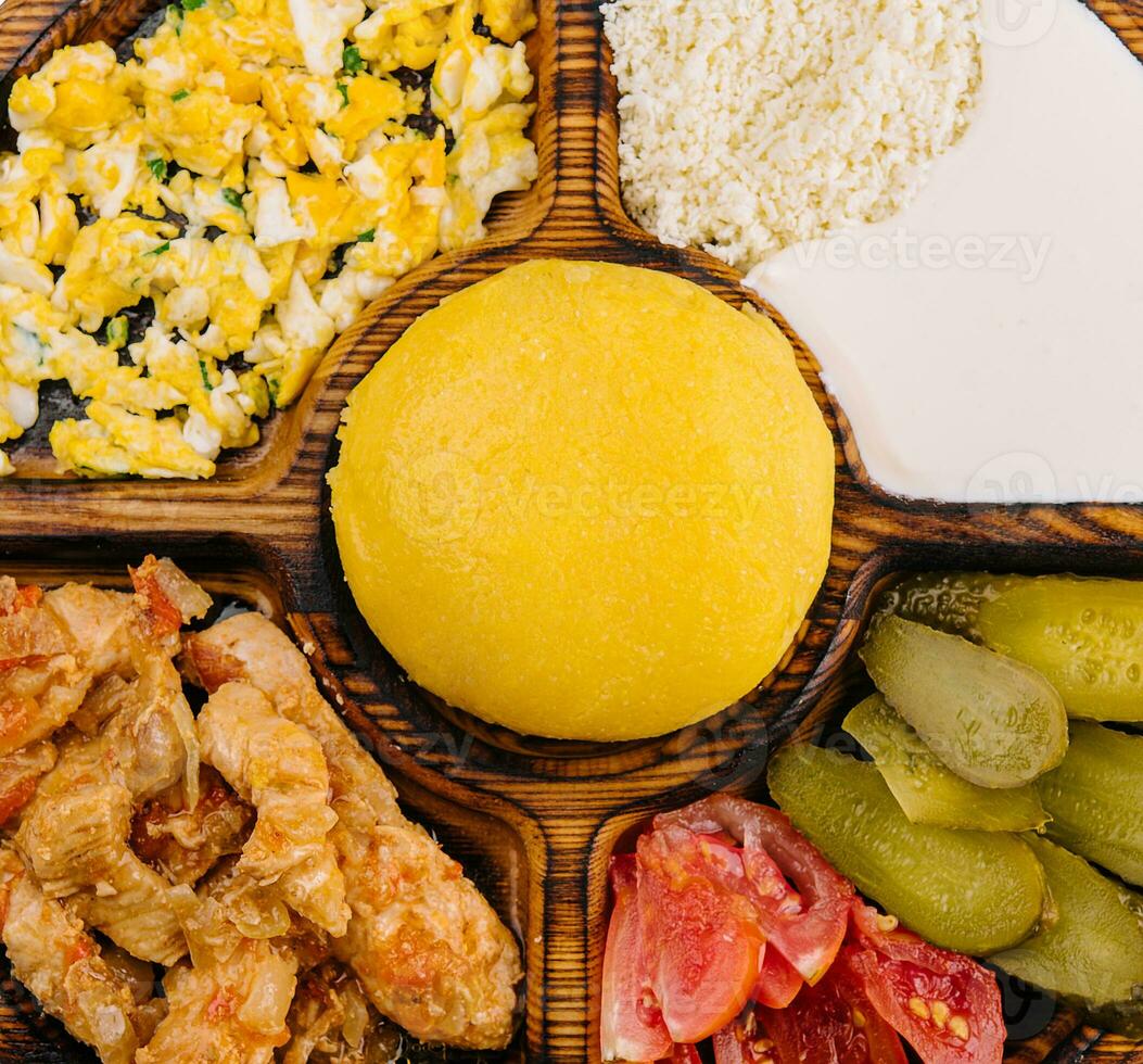 Traditional Moldavian hominy porridge on a wooden tray photo