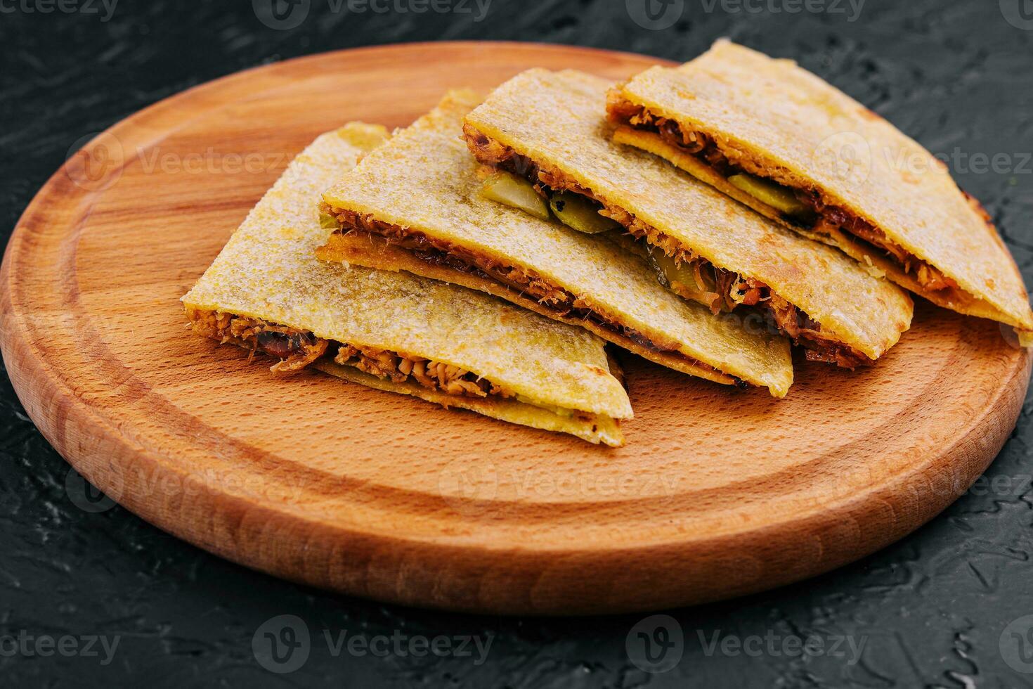 Mexican quesadilla with chicken on wooden table. photo