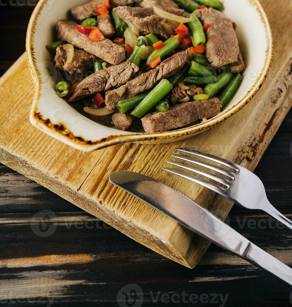 Veal with green beans and chilli pepper photo