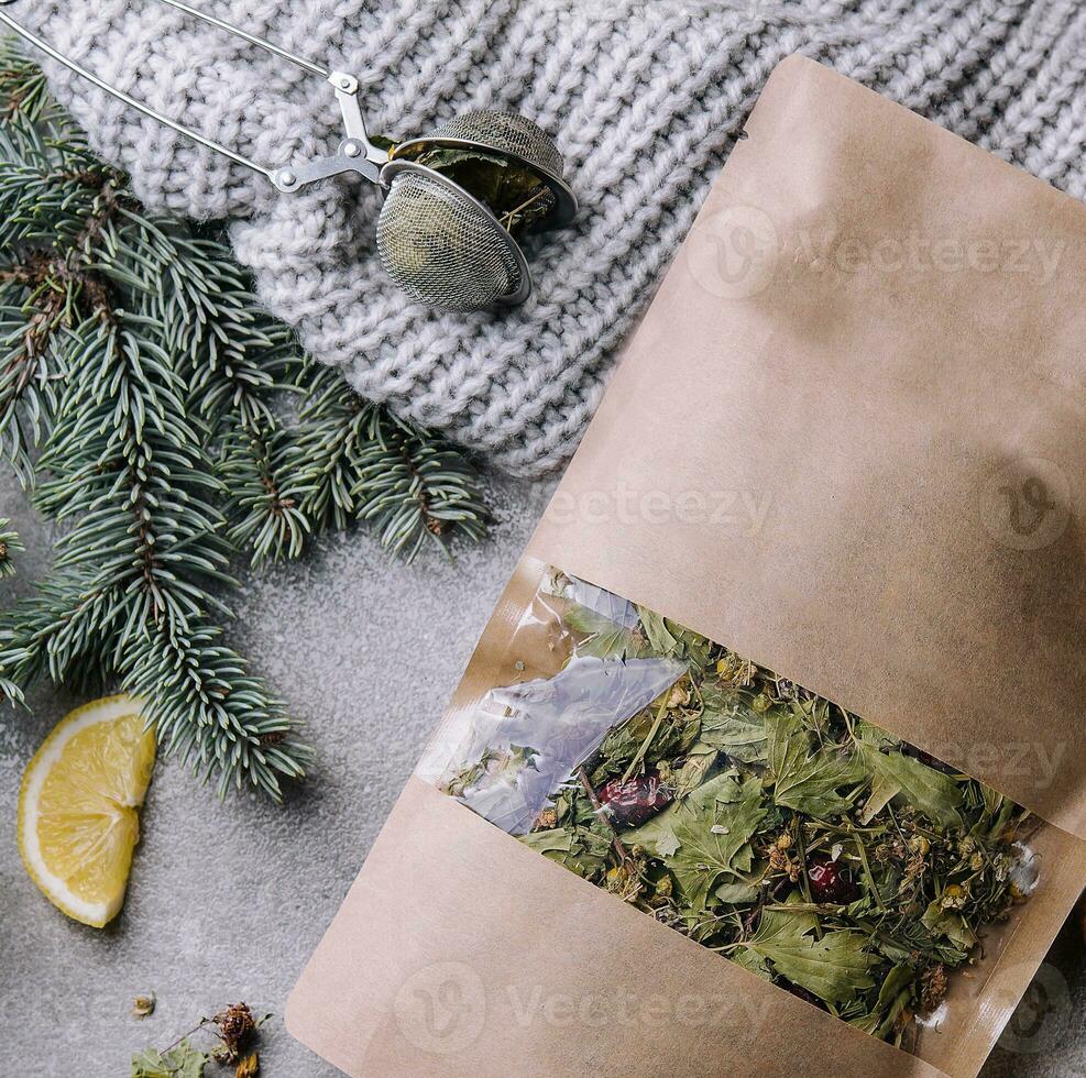 Hot tea in a cup with dried tea in a package photo