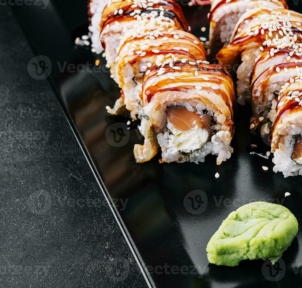 Sushi eel roll maki on black plate photo