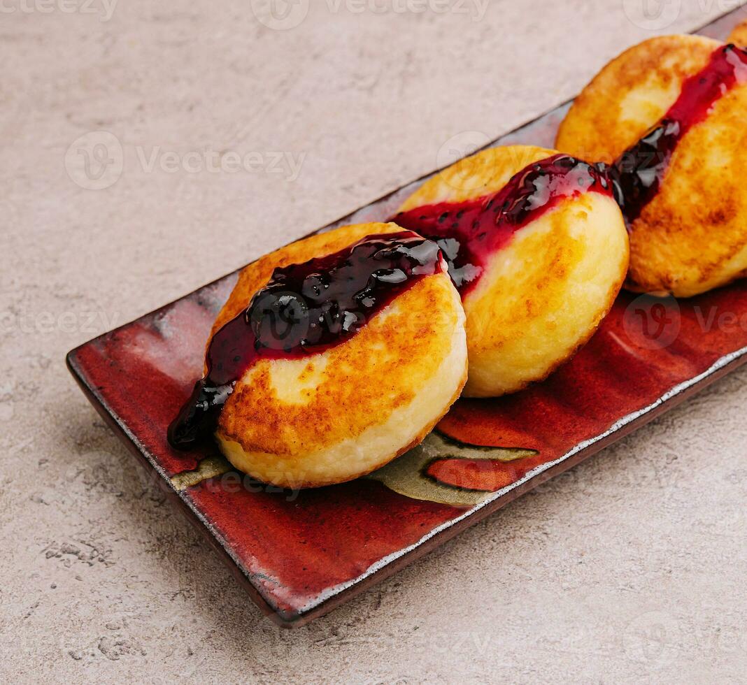 Fritters of cottage cheese with blueberries jam photo