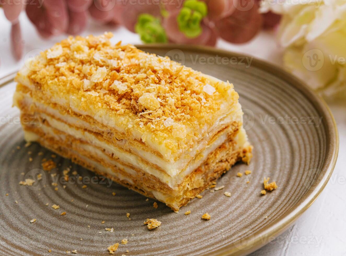 Napoleon cake on plate on table close-up photo