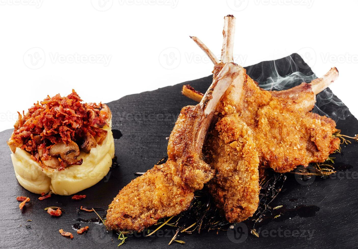 Roasted pork ribs, garnished with onion chips and mashed potatoes photo