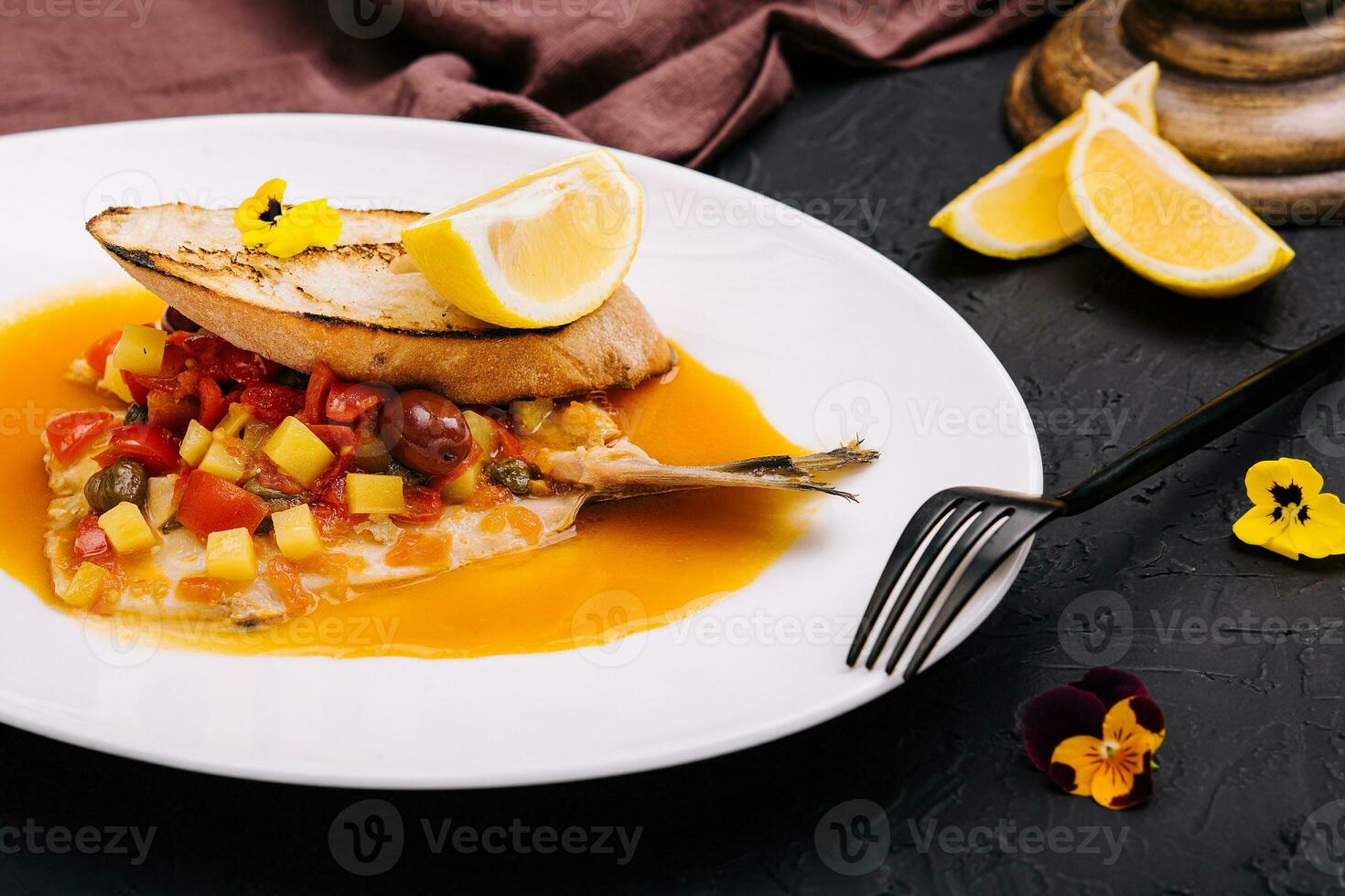 Tasty piece of bread with fried trout fillet photo