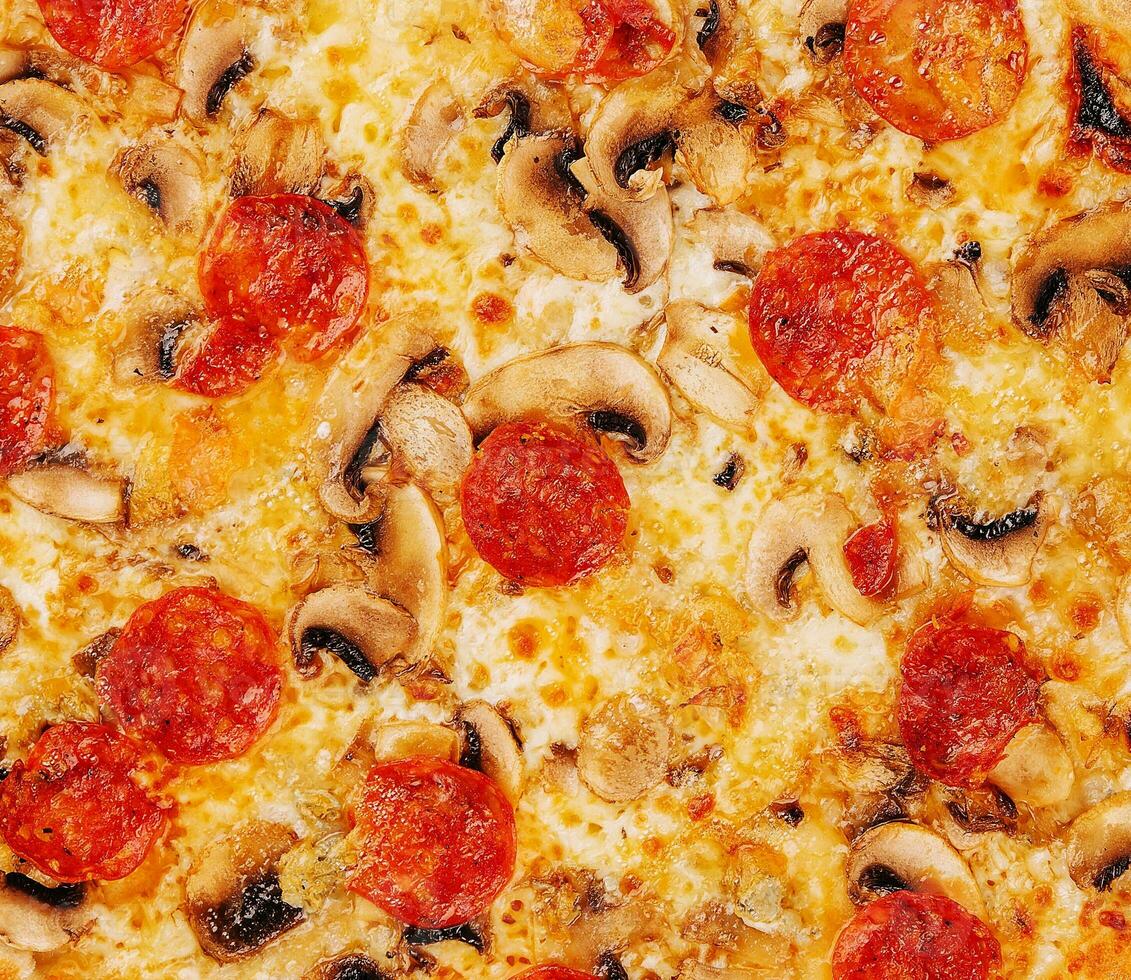 Salami and mushrooms pizza close up background photo