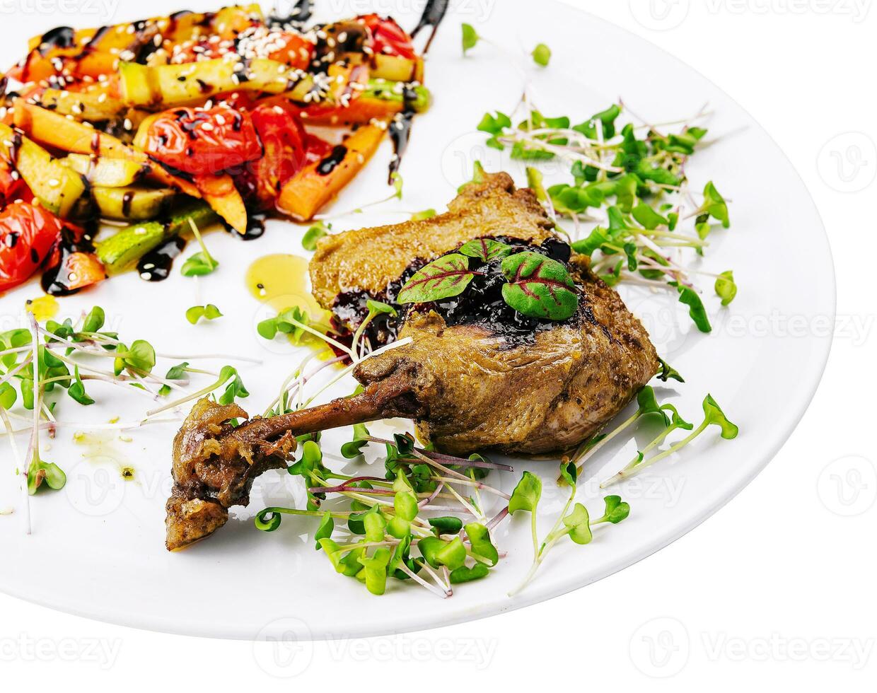 Roasted duck leg with grilled vegetables photo