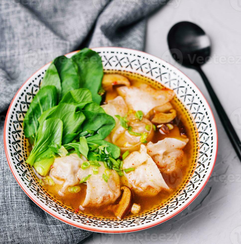 Soup gyoza, dumplings with bok-choy in clear soup photo