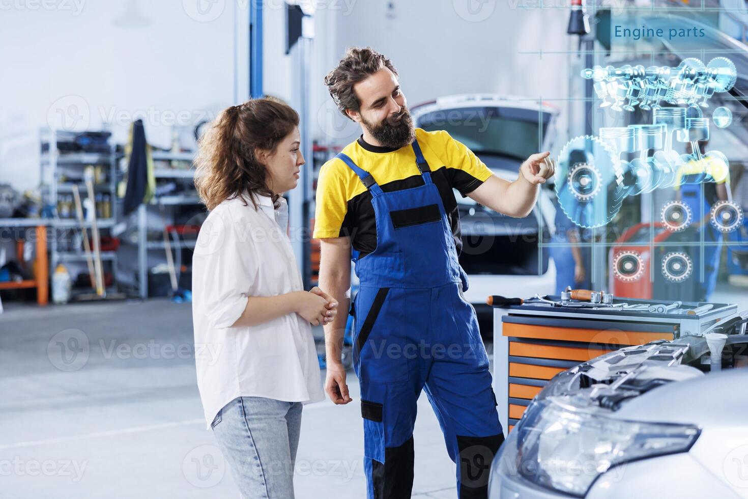 Technician in repair shop using augmented reality holograms to show client car performance parameters during maintenance. Trained garage employee using futuristic vr headset to examine damaged engine photo