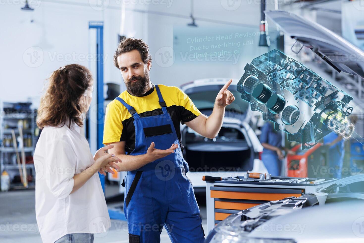 Repairman in repair shop using holographic augmented reality to show customer car performance parameters. Friendly garage employee using futuristic vr headset to examine damaged motor photo