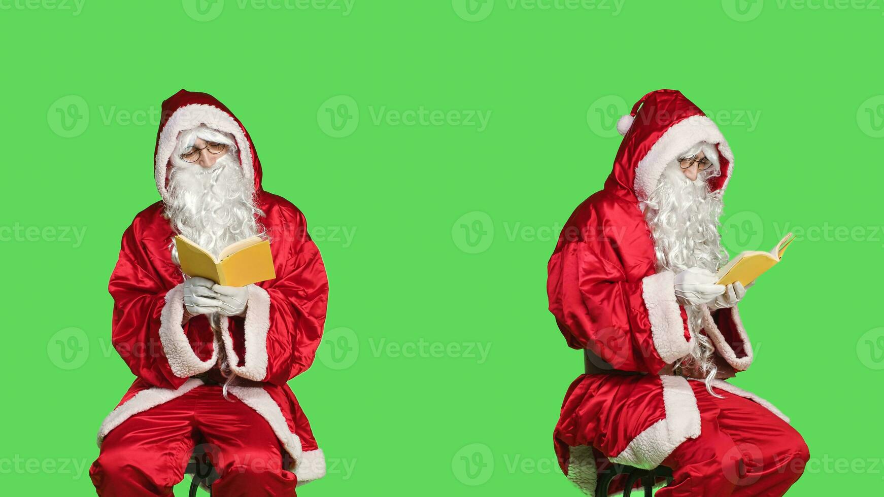 Santa reads literature sitting on chair, man wearing festive red costume while he is reading poetry book over greenscreen backdrop. Father christmas enjoying fairytale story, winter holiday. photo