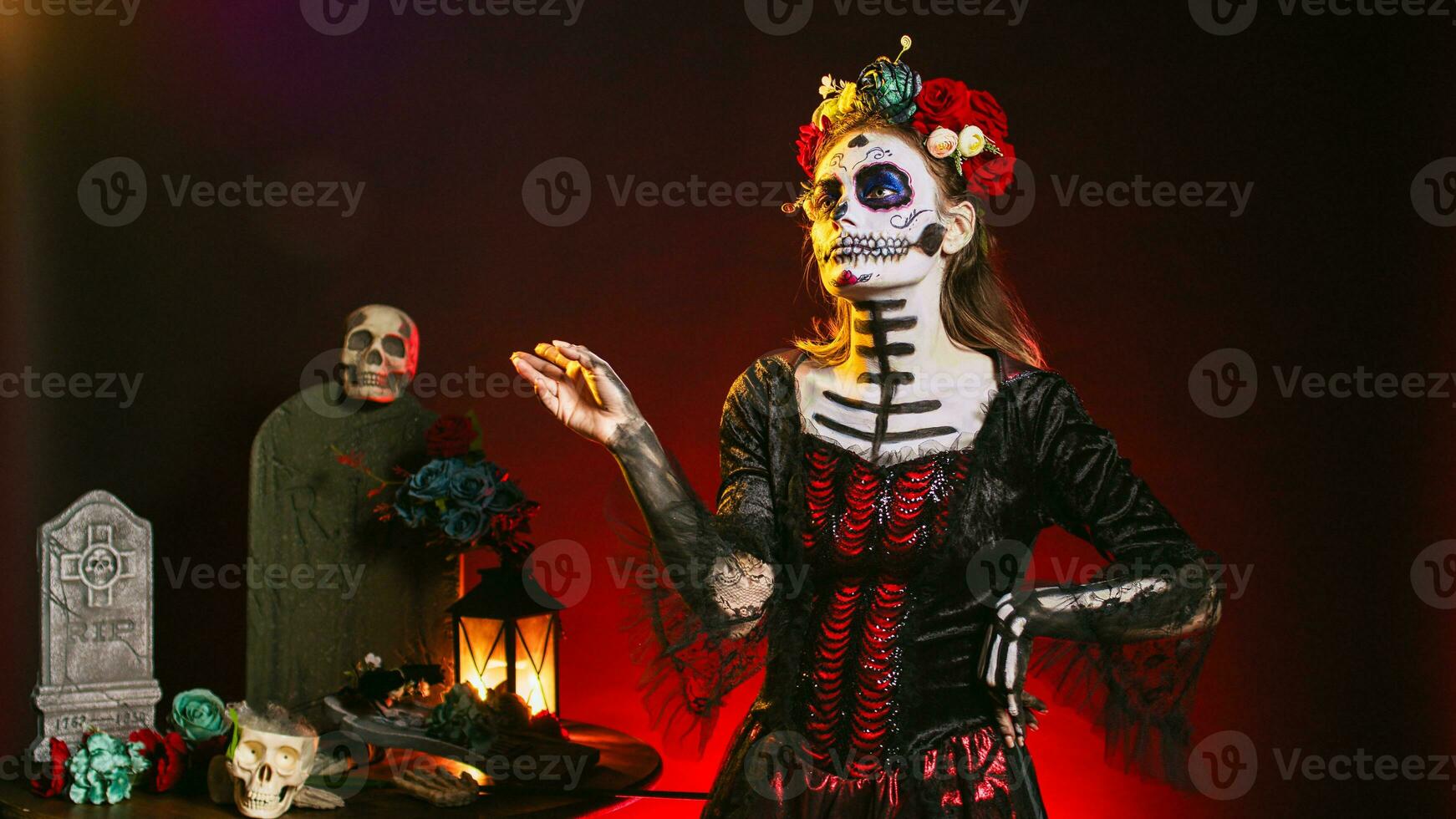 Beautiful horror woman looking at holographic image in studio, using hologram and augmented reality on dios de los muertos. Analyzing artificial intelligence and 3d, celebrating mexican tradition. photo