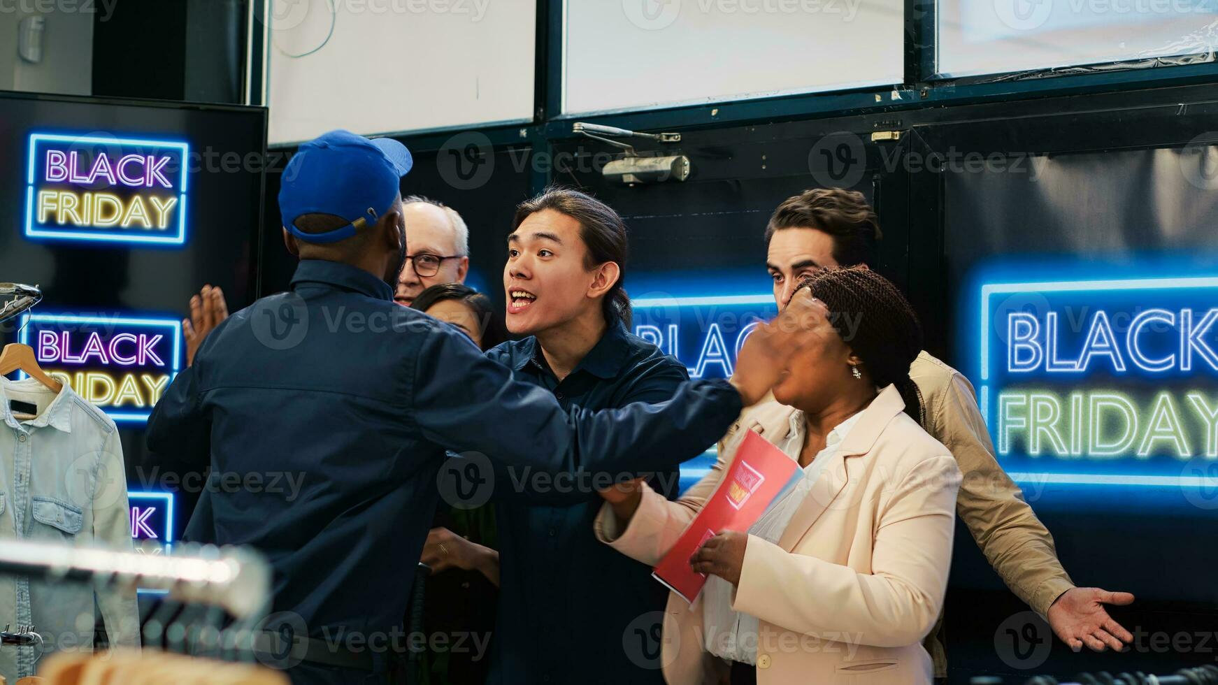 Eager clients going crazy in line to make black friday purchases, enjoy discounted prices and best deals. Violent aggressive people passing security guard at shopping center entrance. photo