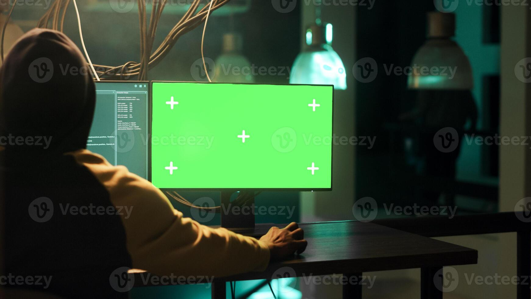Male spy using computer display with greenscreen while stealing government information, planning cybercrime and harassment. Dangerous person breaking passwords, computer malware. photo