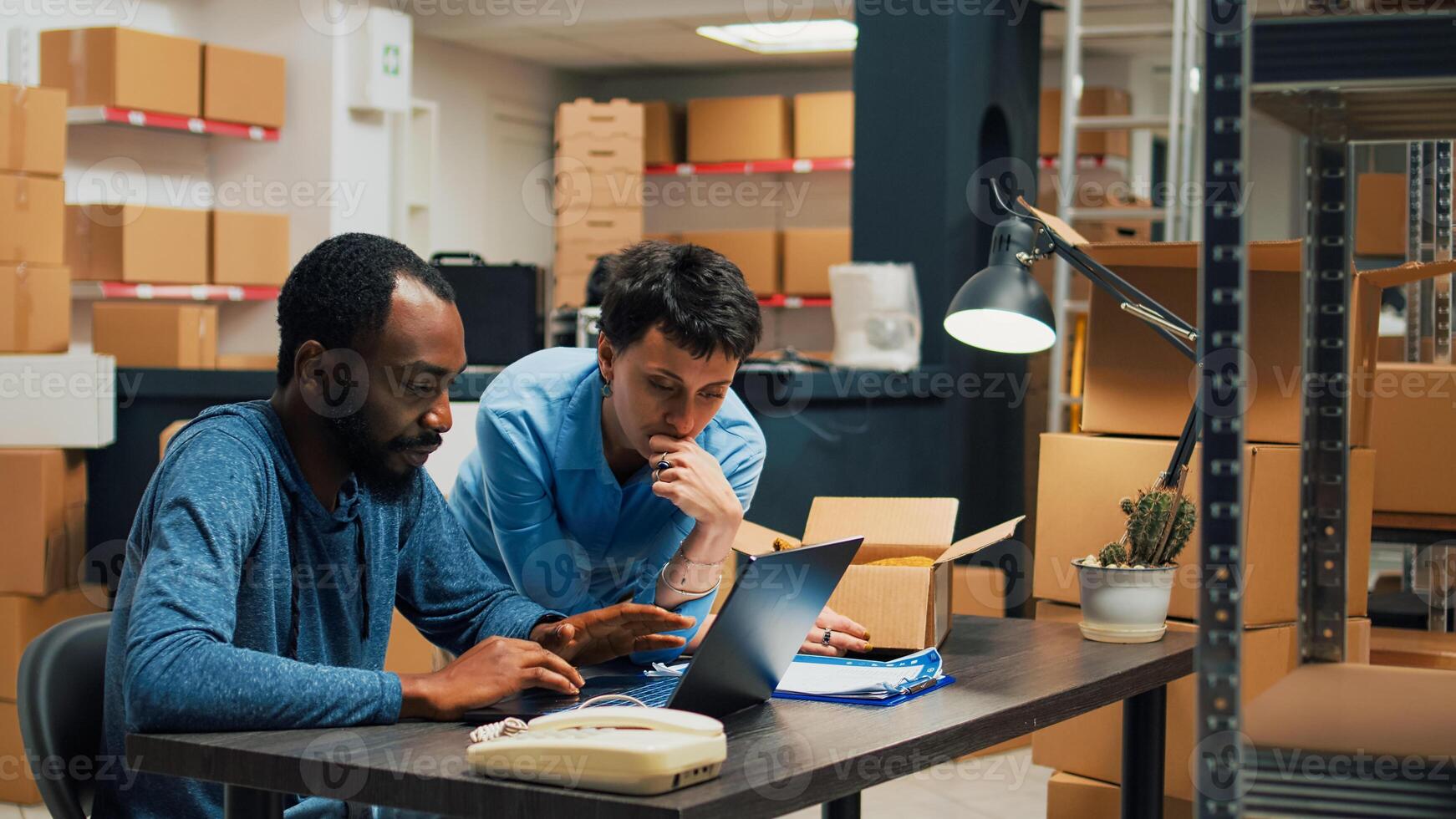 Man and woman checking quality of products packed in carton boxes, preparing order to ship to clients. Team of entrepreneurs working on shipping merchandise and business development. photo