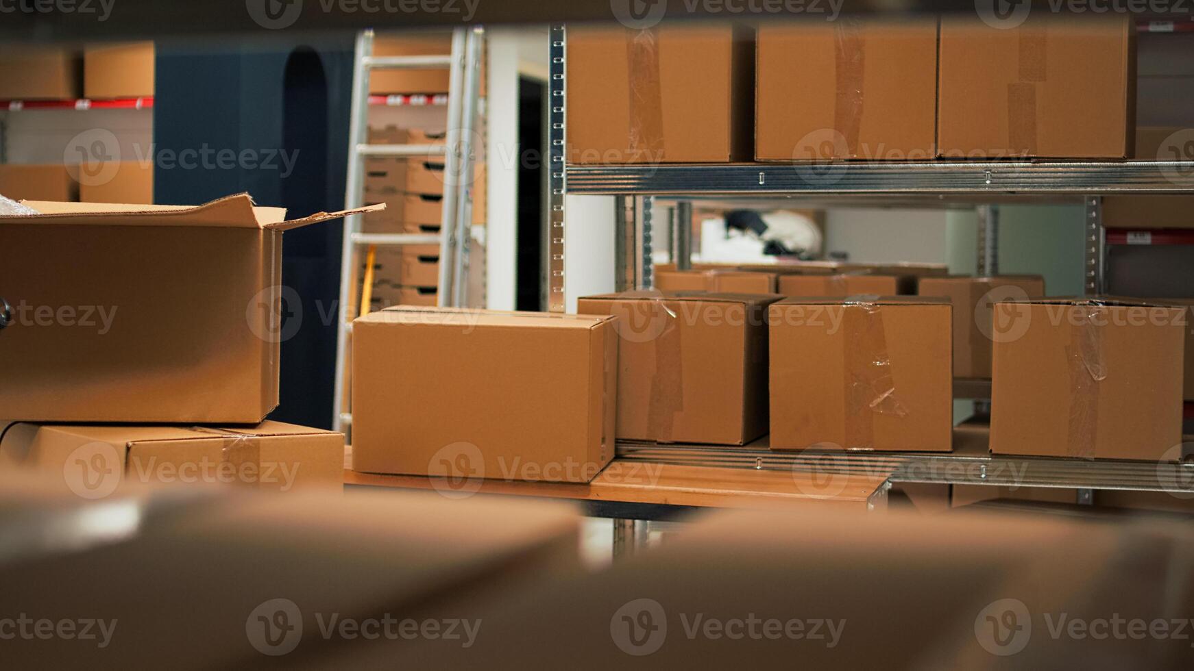 Empty storage space filled with stacks of merchandise and goods, shelves and racks of products in storehouse room. Warehouse used to deliver goods to customers working on logistics. photo