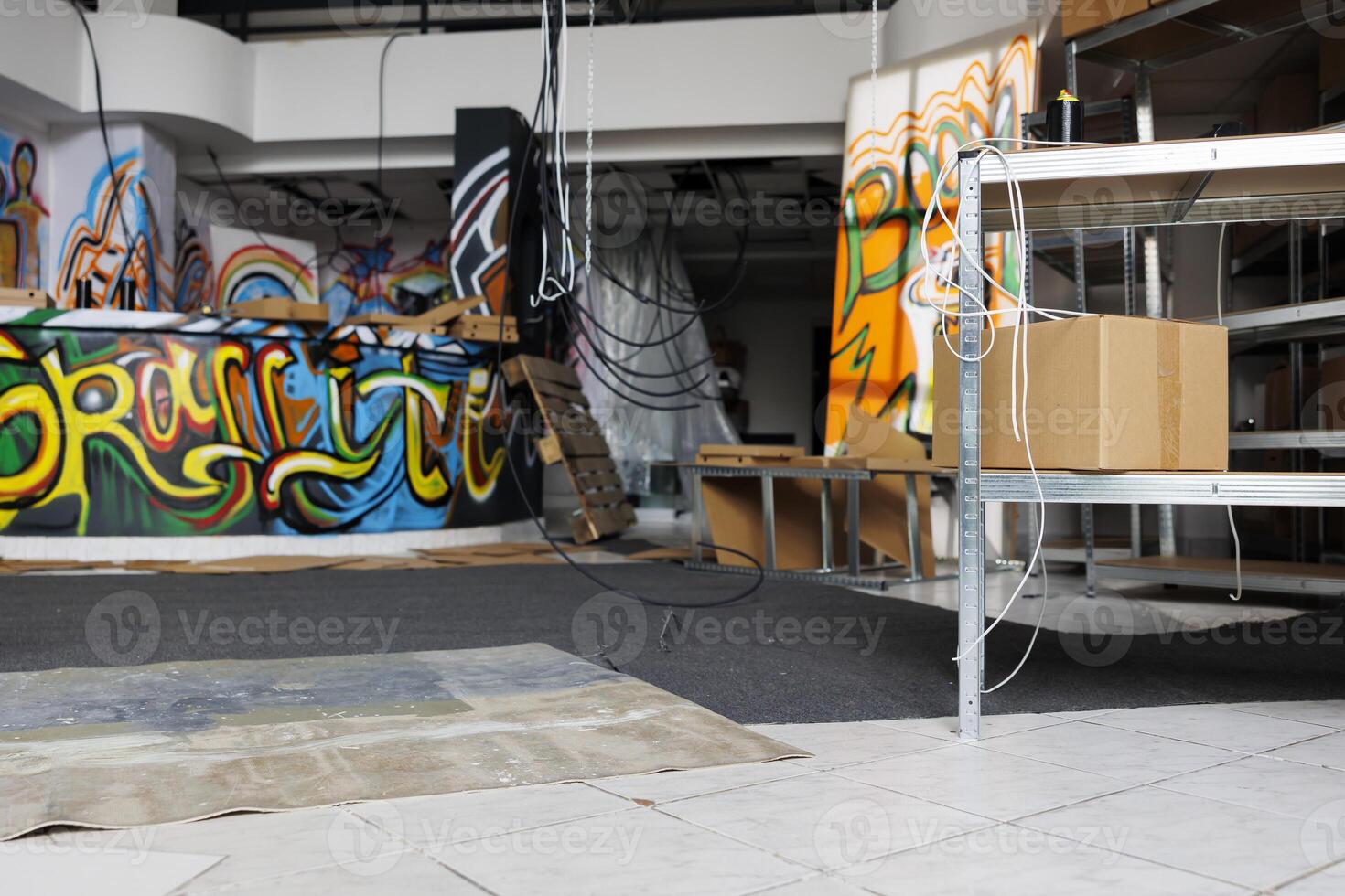 Neglected building in state of disintegration crumbling down, looking messy and deserted. Empty abandoned warehouse with garbage and graffiti spray paint, damaged grungy space. photo