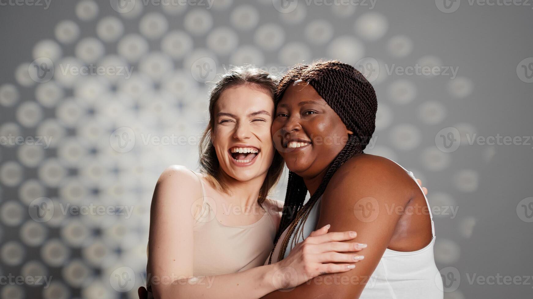 Happy glowing girls laughing and posing in studio, creating ad for body positivity and diversity. Skincare models with different colors and body types promoting femininity and self love. photo