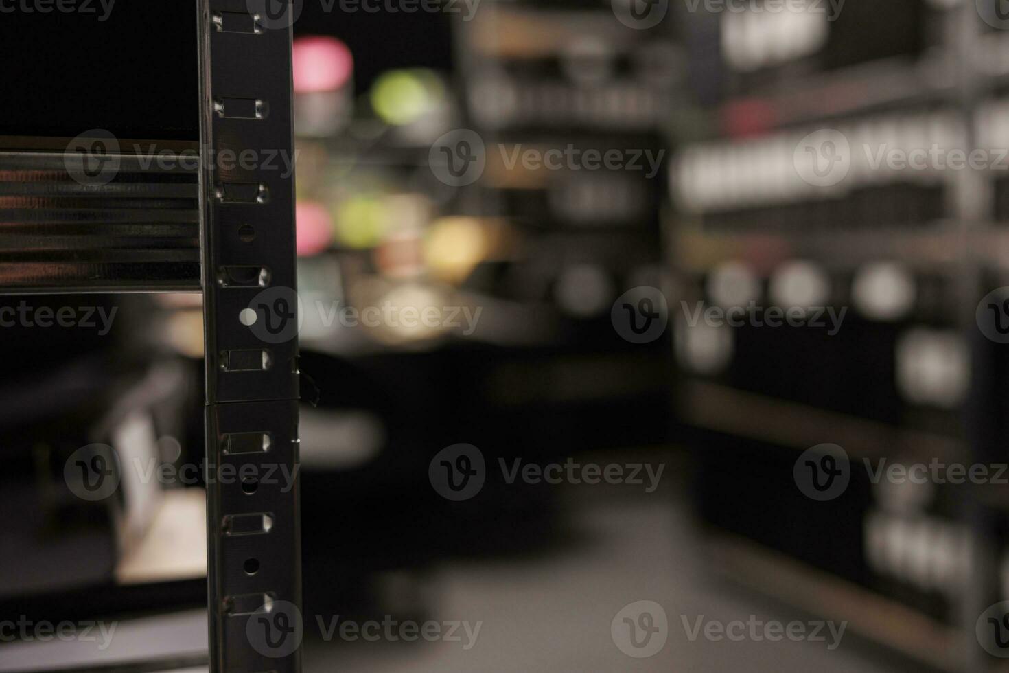 Metal rack for crime case files in detective office room with no people inside. Blurred private investigator agency with shelf for folders close up selective focus at night time photo