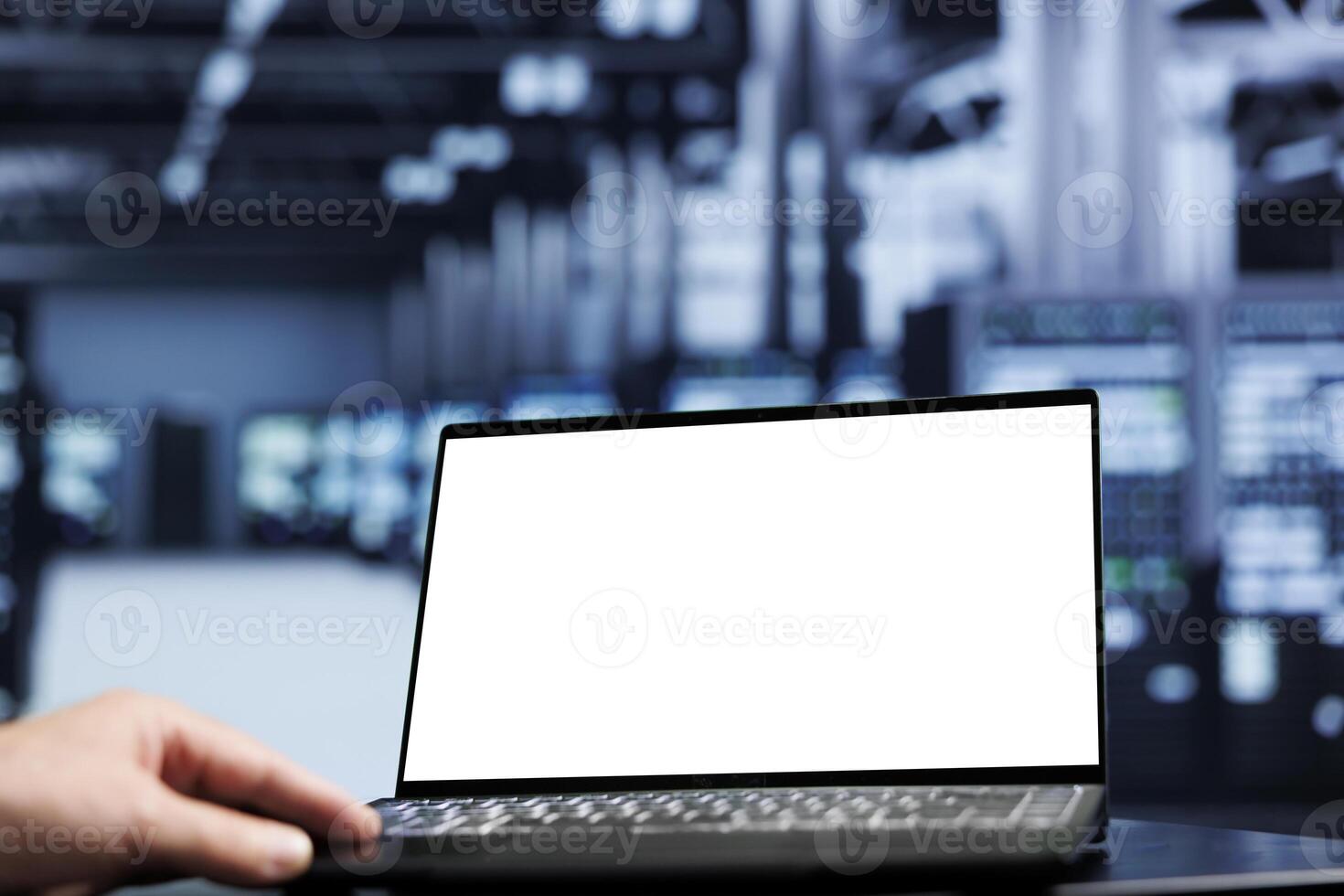 Close up shot of mock up laptop used by proficient repairman in data center using server cabinets to deliver massive computing power, control network resources, process and store datasets photo
