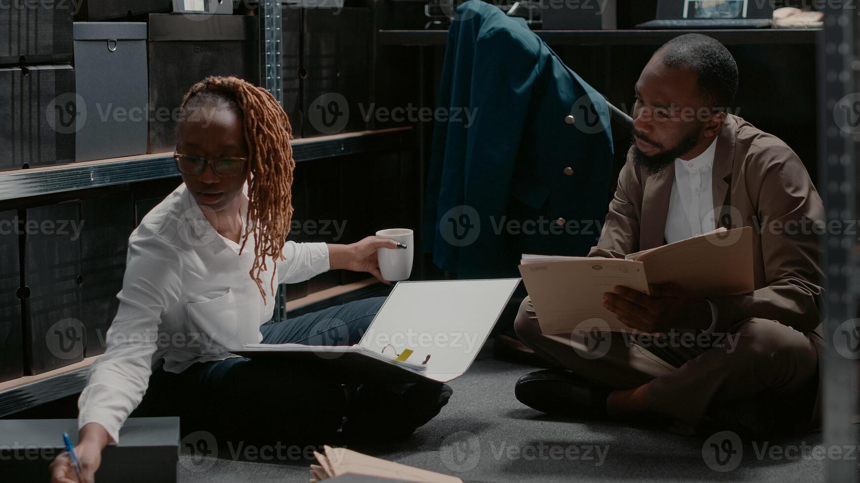 Team of colleagues examining police archive photos to solve case and catch suspect, analyzing physical evidence. Private detectives working in incident room with clues about crime. Handheld shot.