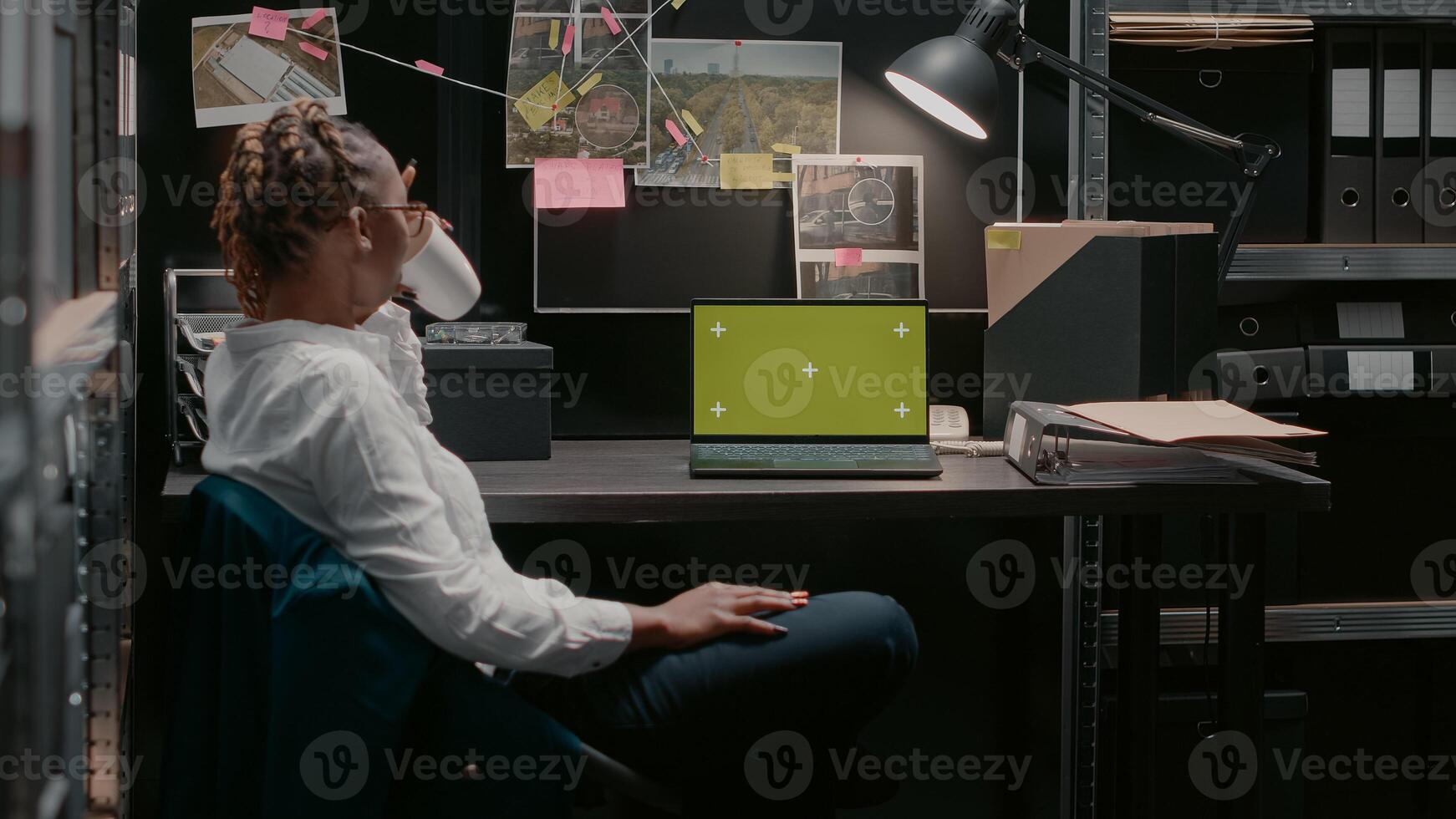 Professional inspector using laptop with greenscreen, analyzing chroma key display and conducting police investigation. Private detective working with isolated mockup copyspace. photo