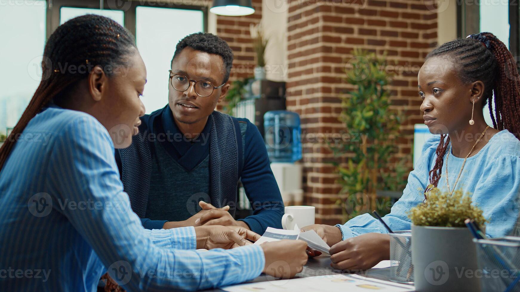 Coworkers team planning new report to work on business development with company analytics, examining research files. Office employees working with annual data results in coworking space, partnership. photo