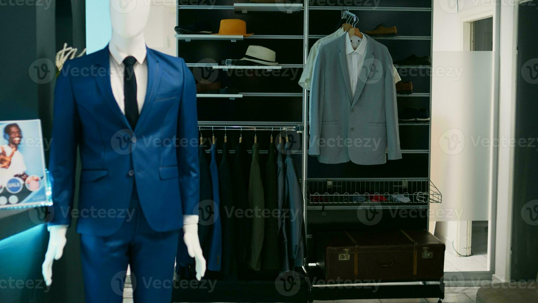 Empty clothing store filled with racks and hangers, elegant formal wear hanging in shopping mall retail boutique. Fashion shop with merchandise on sale, tailoring small business concept. photo