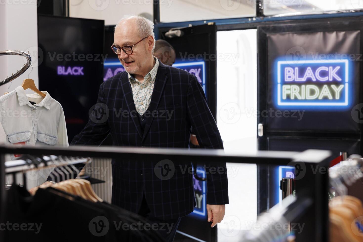 Excited senior man customer entering clothing store on Black Friday, running into shopping mall rushing to buy clothes and discounted prices on biggest famous shopping shopping day photo