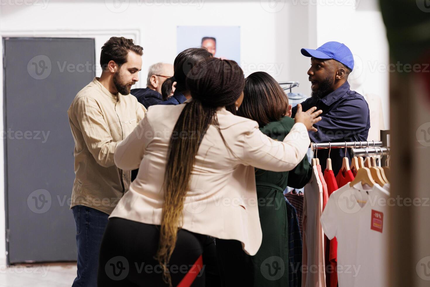 estresado africano americano chico seguridad oficial en pie a ropa Tienda Entrada gerente multitud de compradores rotura dentro Tienda en negro viernes. enojado enojado personas clientes esperando en línea para ventas foto