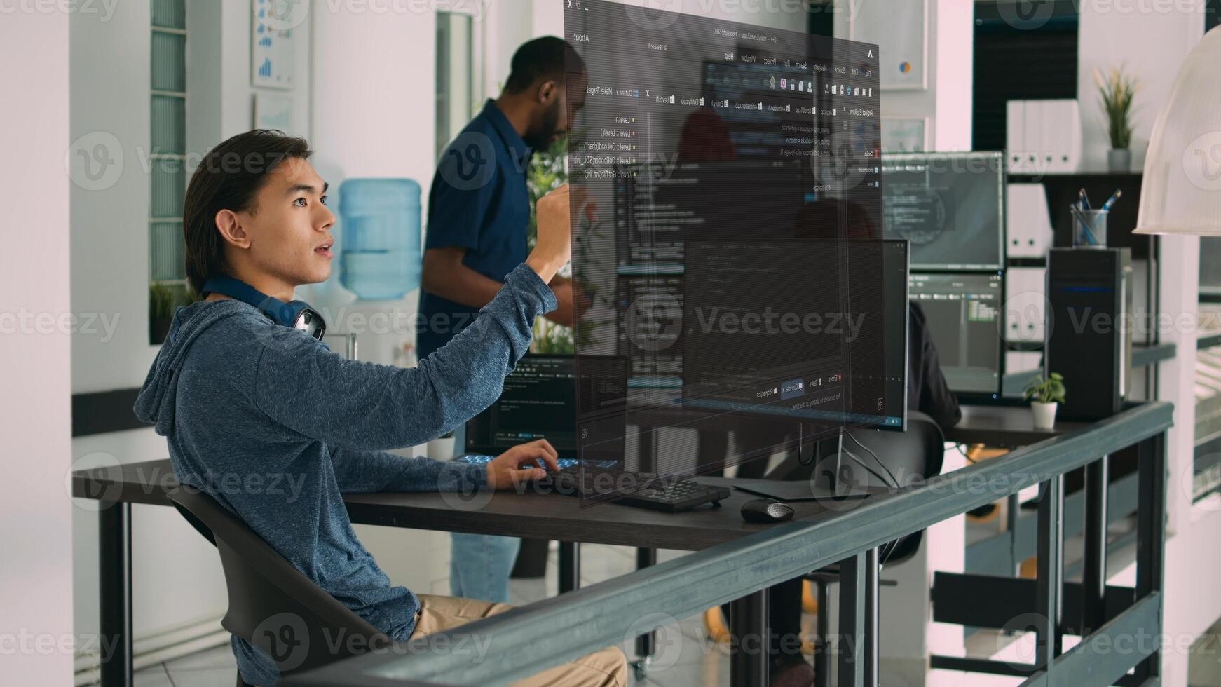 Qualified programmers helped by AR technology to visualize script in coworking space, writing code on computer using Java programming languages. Colleagues solving errors and reinforcing encryption photo