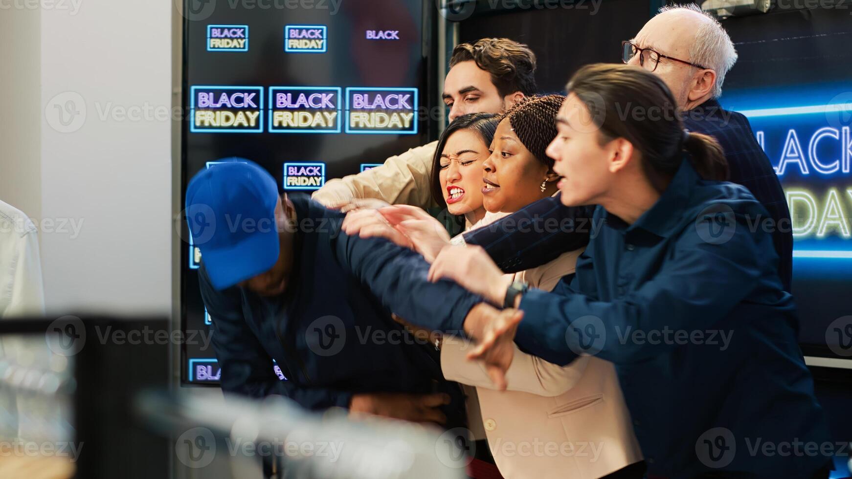 Overwhelmed security guard on black friday trying to push back obsessed crowd of clients, people breaking line into clothing store. Agent calling for reinforcement on big sales day. Handheld shot. photo