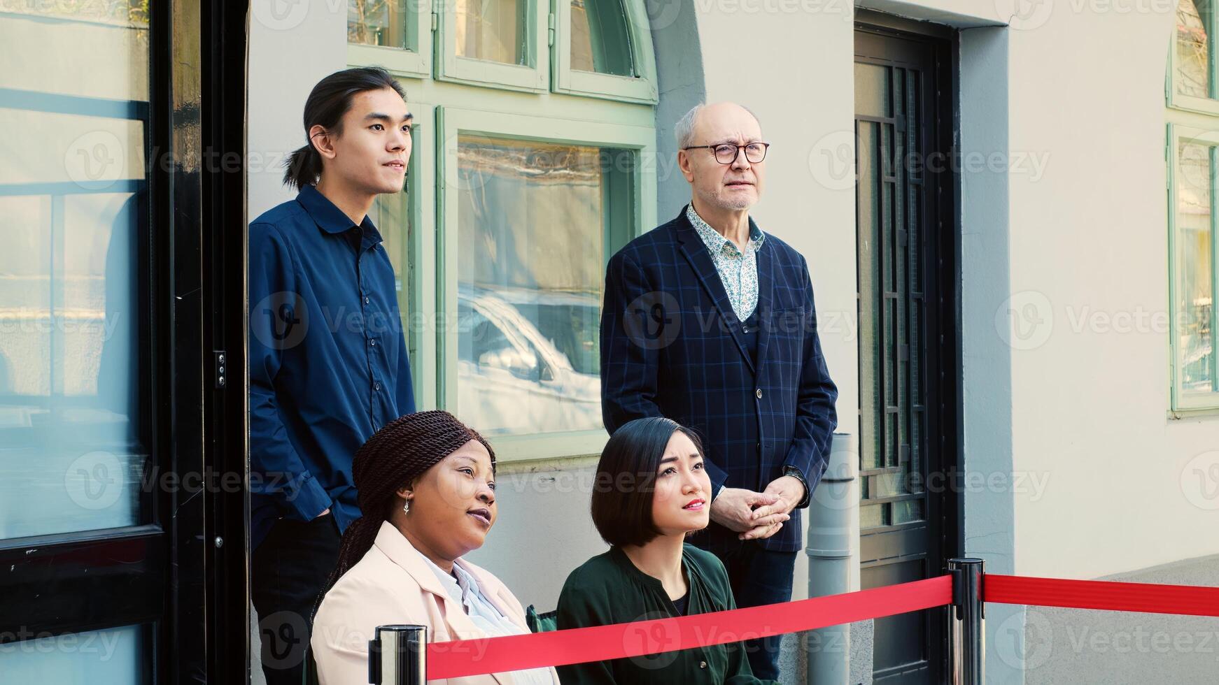 Diverse people waiting outside store, early access to black friday promotional items. Group of customer at clothing outlet front door forming line, having argument with security guard. photo