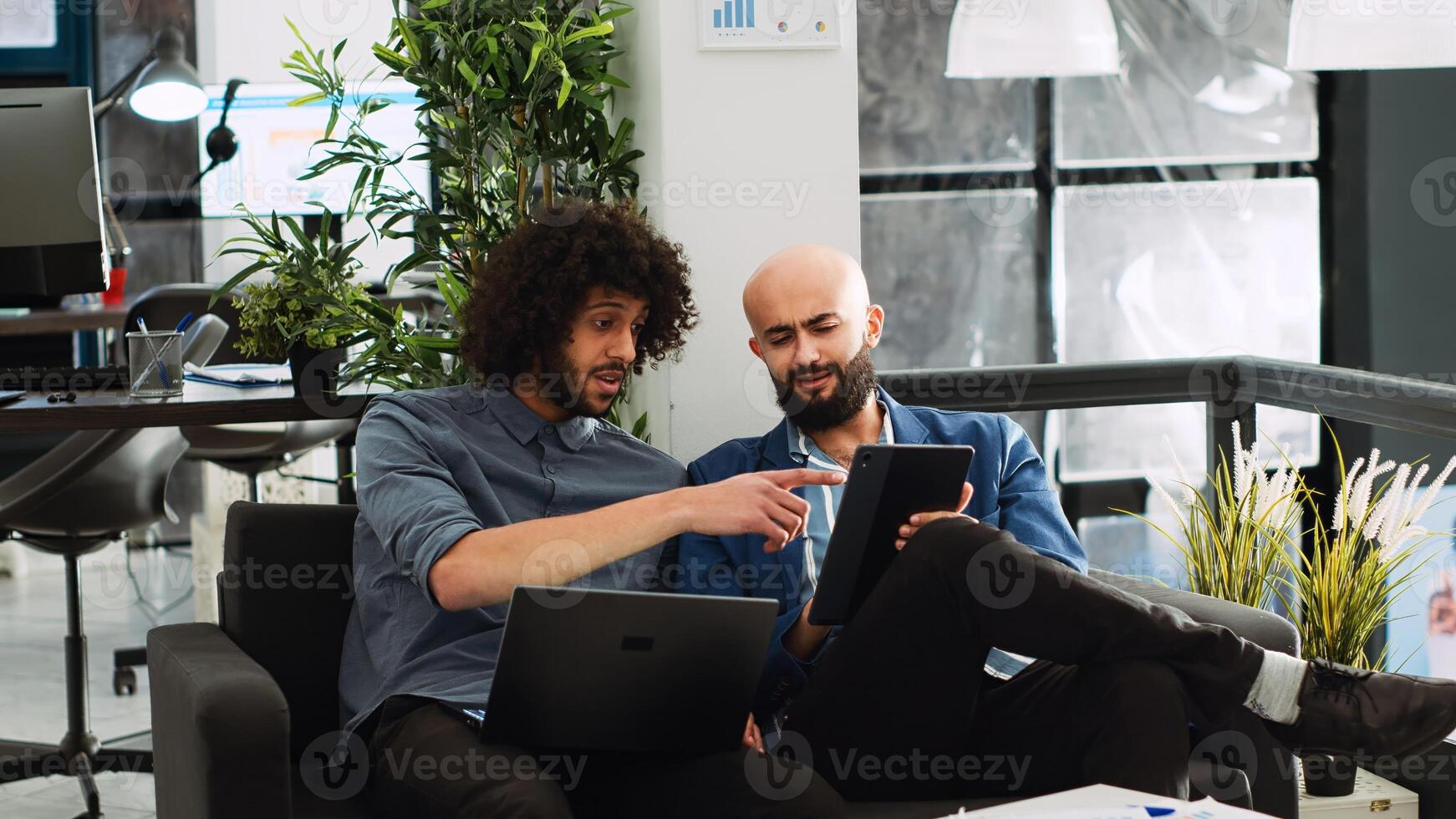 Startup team checking financial report for market analytics, working together to develop profit increasing plan. Middle eastern coworkers discussing project strategy and ideas. photo
