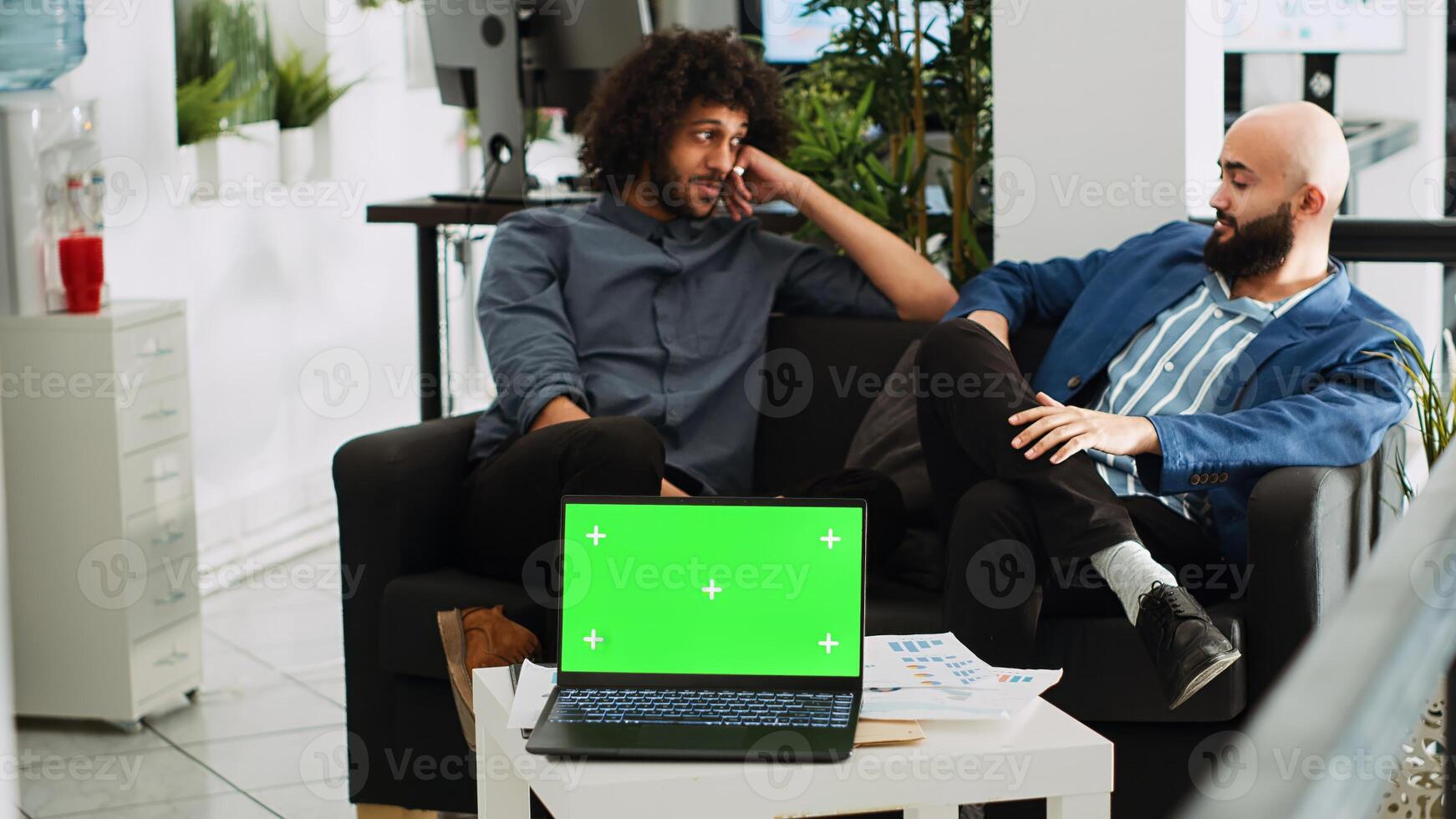 Greenscreen display on laptop in office, business partners discussing about project management. Isolated chromakey template with copyspace concept, modern open floor startup agency. photo