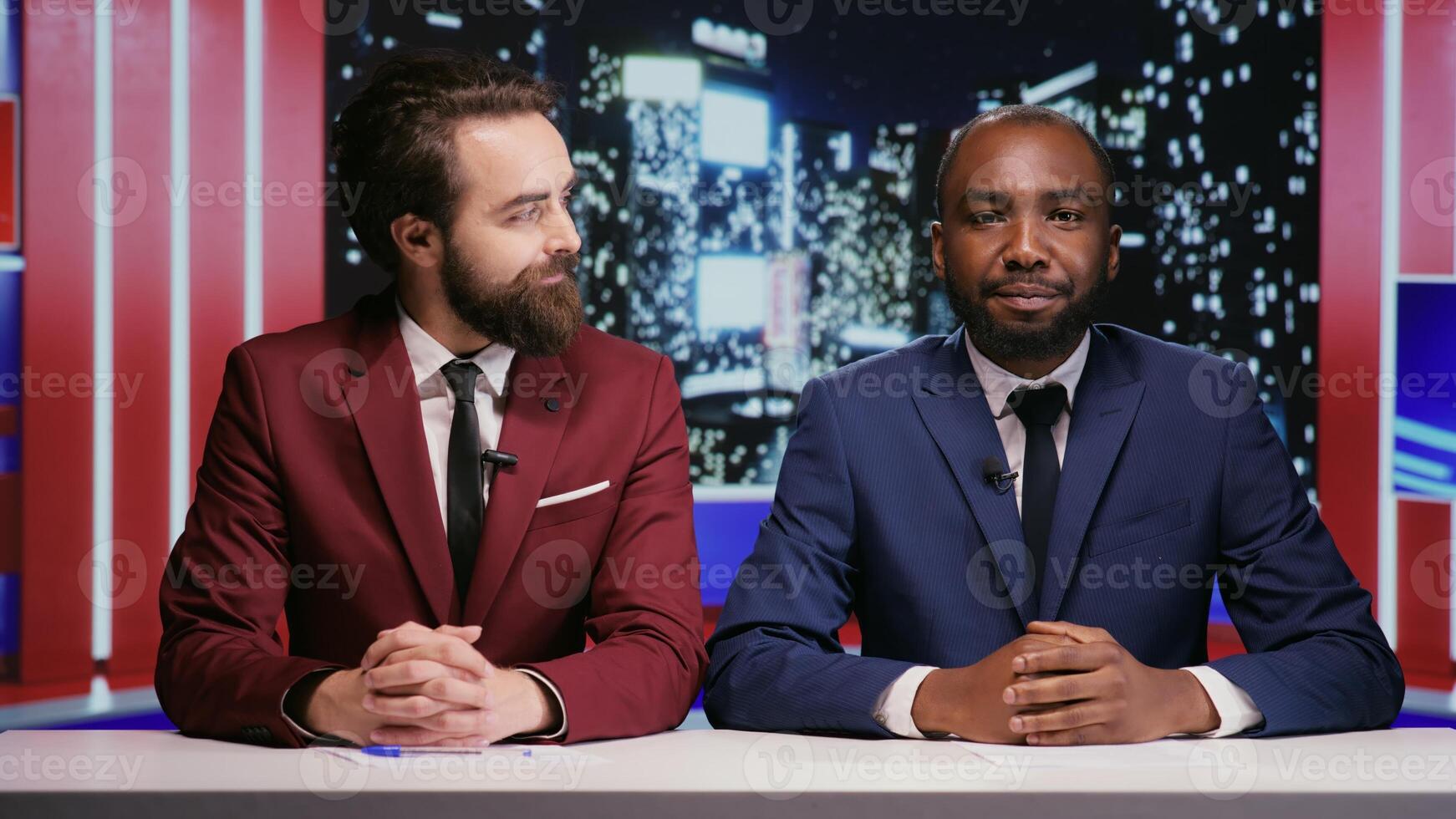 Broadcasters team presenting news live during night show tv program, using daily topics on reportage to discuss about important events. Diverse men presenters talking about global tv network. photo