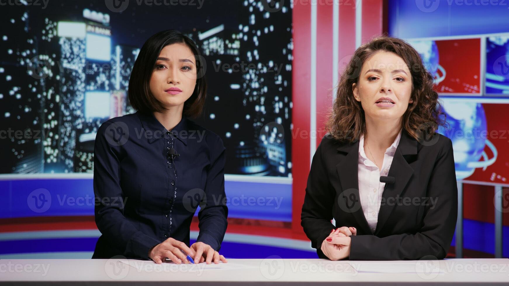 Diverse journalists host night show live on tv network, presenting breaking news segment in newsroom. Media presenters team addressing daily international events with television reportage. photo