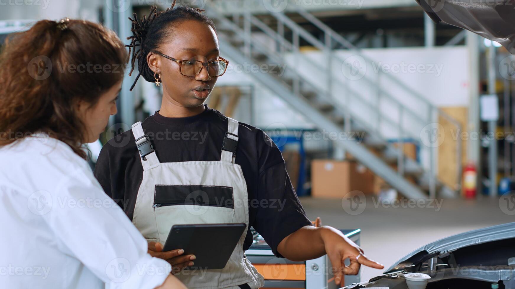 Licensed engineer in car service using tablet to calculate repairments invoice for client after fixing damages. Trained expert using device to determine final costs after servicing vehicle, close up photo