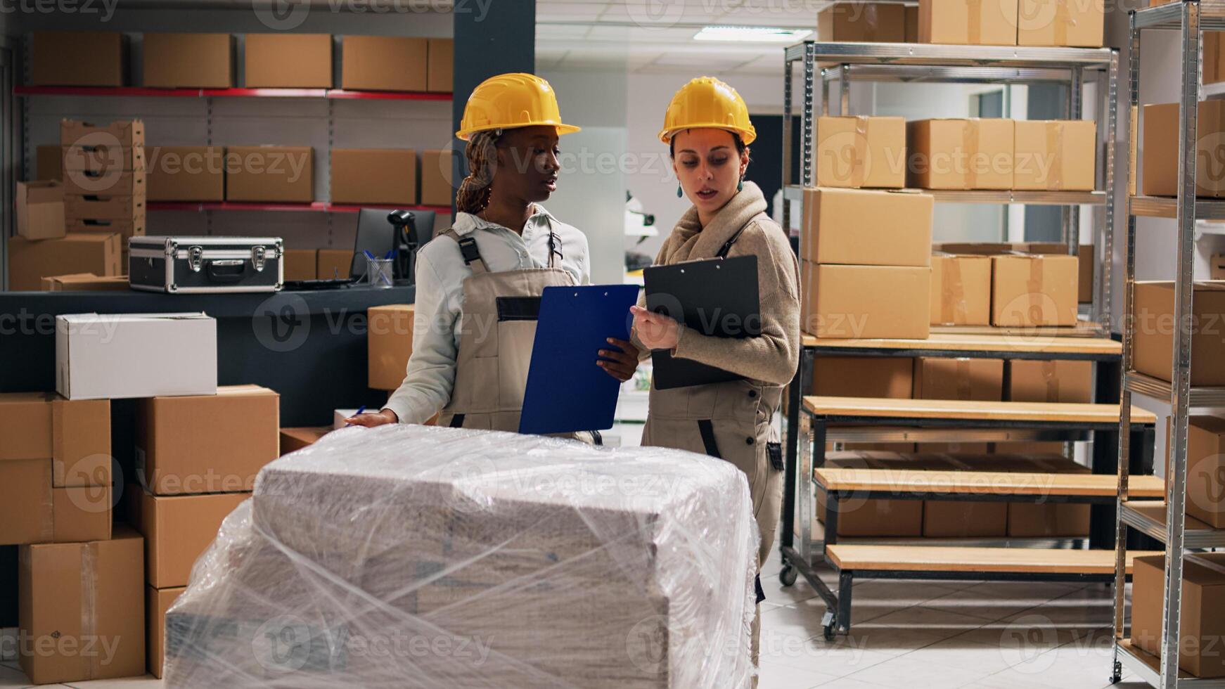 Diverse group of people analyzing products in depot and working on stock inventory for delivery logistics. Young employees planning distribution with merchandise in packages, cargo service. photo