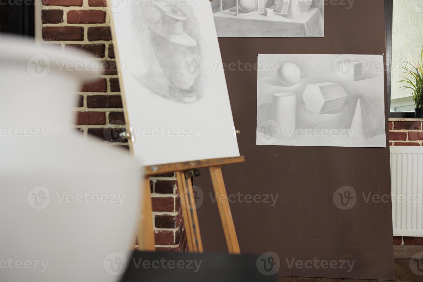 Developing sketching skills in fine arts school, learning pencil drawing techniques. Wooden easel with sketch of vase in modern studio, no people. Creative artist workplace, art studio interior photo