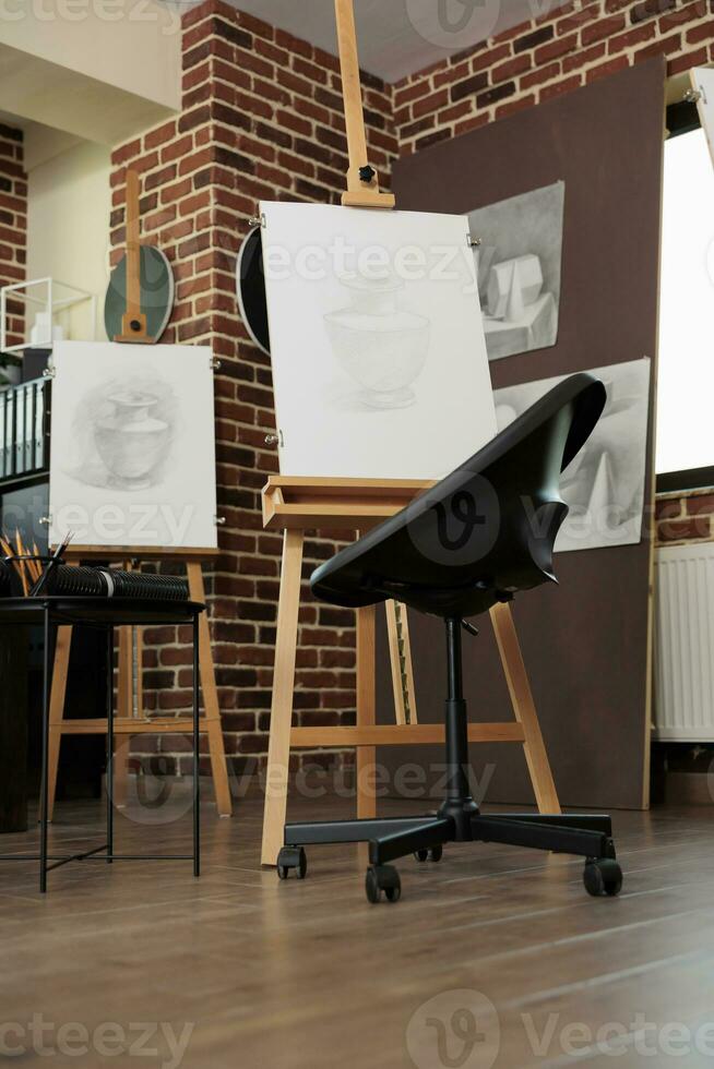 Art classroom interior with easels and drawing tools, nobody. Sketching classes and workshops in fine art for adults, sketch artworks in empty artist studio. Hobby to develop creativity photo