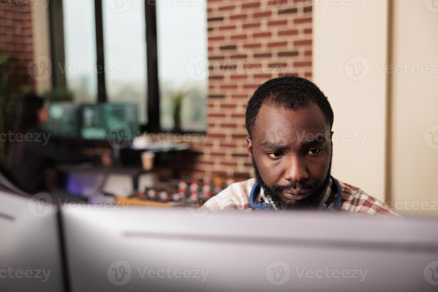 Software developer typing javascript code on computer to develop online cloud computing information. African american tech enginner writing html script and data algorithm, working in it office photo