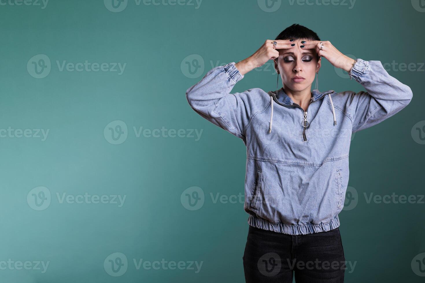 Frustrated nervous model putting hand on forehead trying not to scream after hearing the bad news during studio shot, posing over isolated background. Sad unhappy woman having displeased expression photo