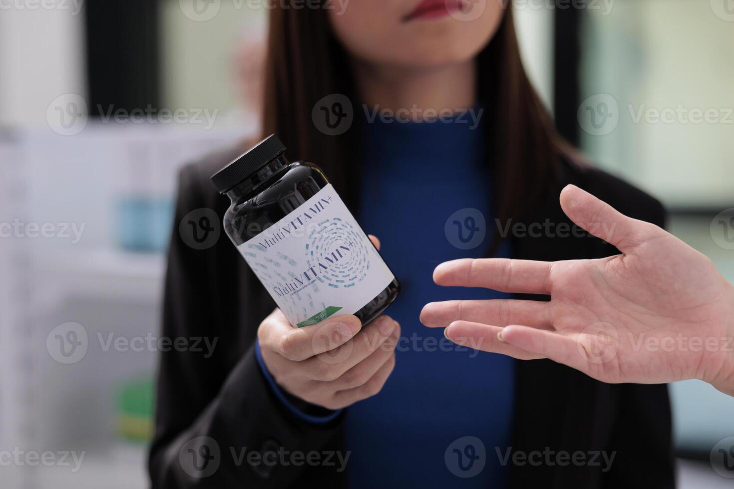 Woman getting chemist consultation about multivitamin complex in drugstore. Medical retail store customer asking pharmacy assistant about dietary supplement advice, showing vitamin bottle close up photo